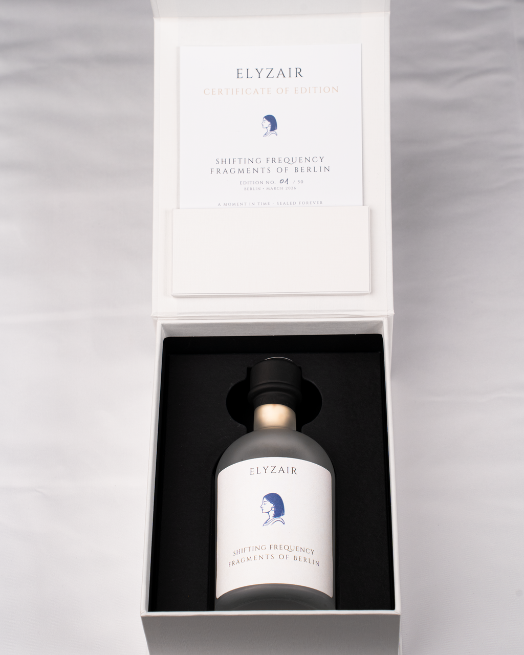 Opened ELYZAIR edition box with the certificate of edition and the sealed bottle in its black insert