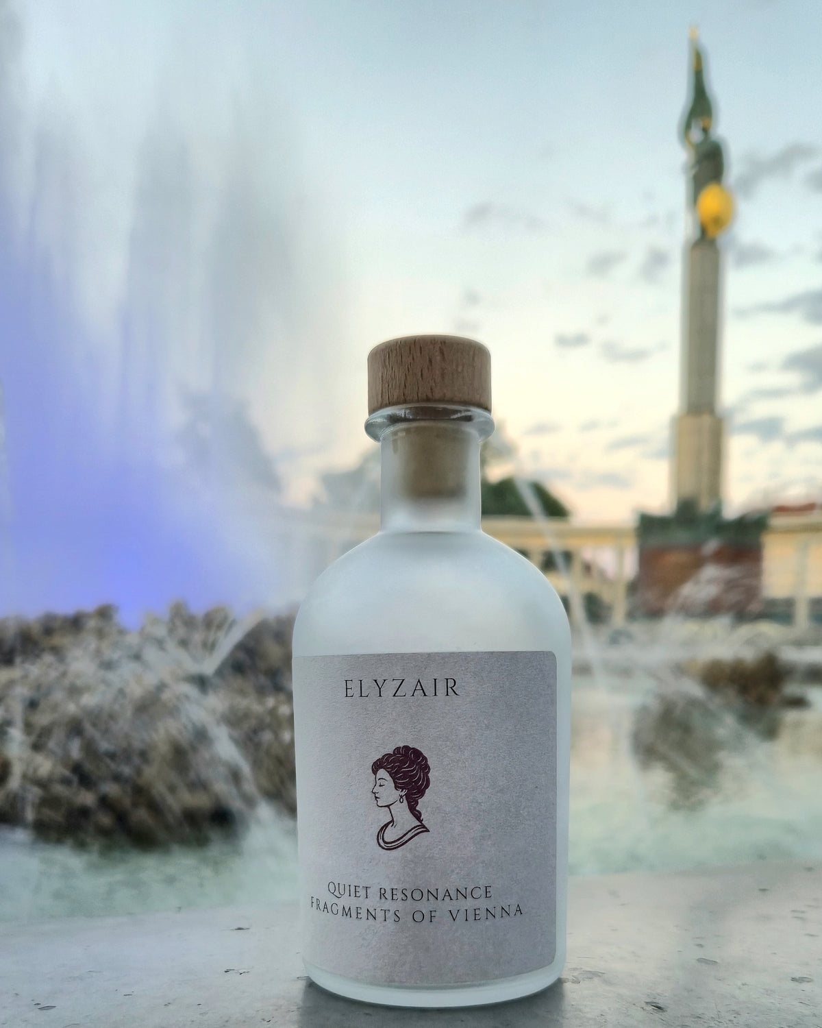 ELYZAIR Quiet Resonance, sealed glass edition of Vienna, in front of a fountain, spray drifting behind